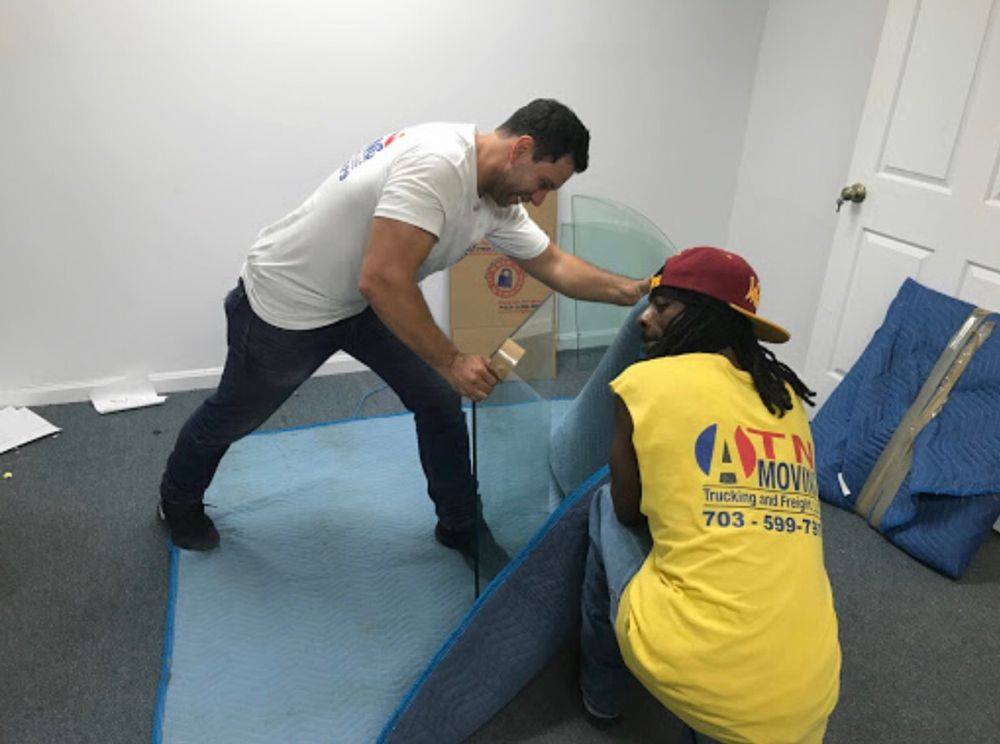 ATN Movers securely wrapping up fragile glass pieces